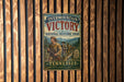 a vintage-style metal sign with the text "Overmountain Victory National Historic Trail" and "Tennessee" printed on it, mounted on a wooden wall.