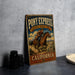 A vintage-style metal sign for Pony Express National Historic Trail in California, featuring a cowboy riding a horse.
