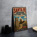 a vintage-style sign for the Santa Fe National Historic Trail in Kansas, with a wagon train illustration and the text "America's Heritage Trail" prominently displayed.