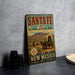 A vintage-style sign for the Santa Fe National Historic Trail in New Mexico, featuring an illustration of a covered wagon and a desert landscape.