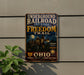 a vintage-style sign for the Underground Railroad Network to Freedom Trail, mounted on a wall next to a plant.