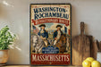 A vintage-style sign for the "Washington-Rochambeau Revolutionary Route" in Massachusetts, featuring two men in military uniforms riding horses.