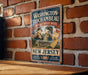 A vintage-style metal sign with the text "WASHINGTON-ROCCHAMBEAU REVOLUTIONARY ROUTE" and "NEW JERSEY" printed on it, mounted on a brick wall.