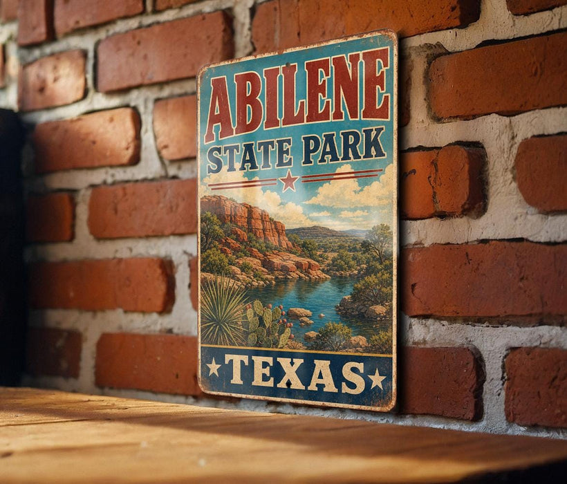 A vintage-style sign for Abilene State Park in Texas, featuring a scenic landscape with mountains, water, and desert vegetation.