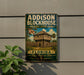 A metal sign for Addison Blockhouse Historic State Park in Florida, featuring a wooden fort-like structure and a palm tree.