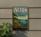 A vintage-style metal sign for Afton State Park in Minnesota, featuring a scenic landscape with a river, mountains, and a boat.