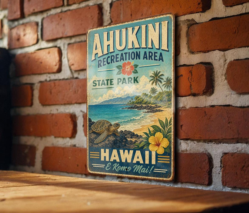 A vintage-style metal sign with the text "AHUKINI RECREATION AREA STATE PARK HAWAII E REMO MA!" displayed on a brick wall.