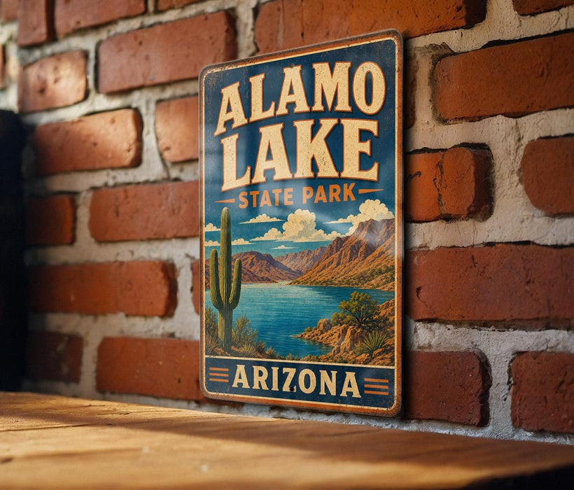 A vintage-style metal sign for Alamo Lake State Park in Arizona, featuring a desert landscape with a cactus and a lake.