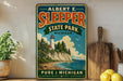 A vintage-style metal sign for Albert E. Sleeper State Park in Michigan, featuring a lighthouse and a coastal landscape.