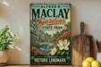 A vintage-style sign for Alfred B. Maclay Gardens, a historic landmark in Tallahassee, Florida, featuring a tropical garden scene with a bridge and flowers.