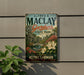 A vintage-style metal sign for Alfred B. Maclay Gardens, featuring a scenic illustration of the park and its surroundings.