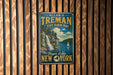 A vintage metal sign for Allan H. Treman State Marine Park, featuring a scenic image of a waterfall and a sailboat on Finger Lakes, New York.