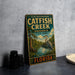 A vintage-style metal sign for the Catfish Creek Preserve in Florida, featuring an illustration of a bird and a pond surrounded by trees.