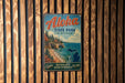 A vintage-style metal sign for Aloha State Park in Michigan, featuring a scenic image of the park and its surrounding landscape.
