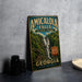 A vintage-style metal sign for Amicalola Falls State Park in Georgia, featuring a waterfall and lush greenery.
