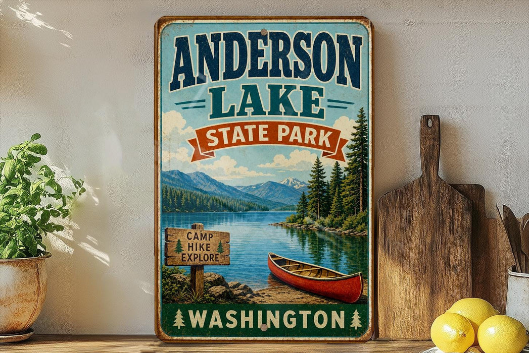 A vintage-style sign for Anderson Lake State Park in Washington, featuring a scenic image of a lake, mountains, and a canoe.