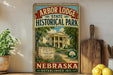 a vintage-style sign for Arbor Lodge State Historical Park in Nebraska, with a house illustration and text indicating the park's location.