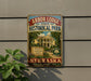 A vintage-style metal sign for Arbor Lodge State Historical Park in Nebraska, featuring an illustration of a historic lodge surrounded by trees and a path leading to the lodge.