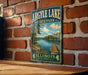 A vintage-style metal sign for Argyle Lake State Park in Illinois, featuring a scenic image of the lake and surrounding landscape.