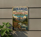 A vintage metal sign for Arkansas Headwaters Recreation Area State Park in Colorado, featuring a scenic mountain landscape and a river.