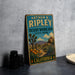 A vintage-style sign for Arthur B. Ripley Desert Woodland State Park in California, featuring a desert landscape with a cactus and colorful flowers.