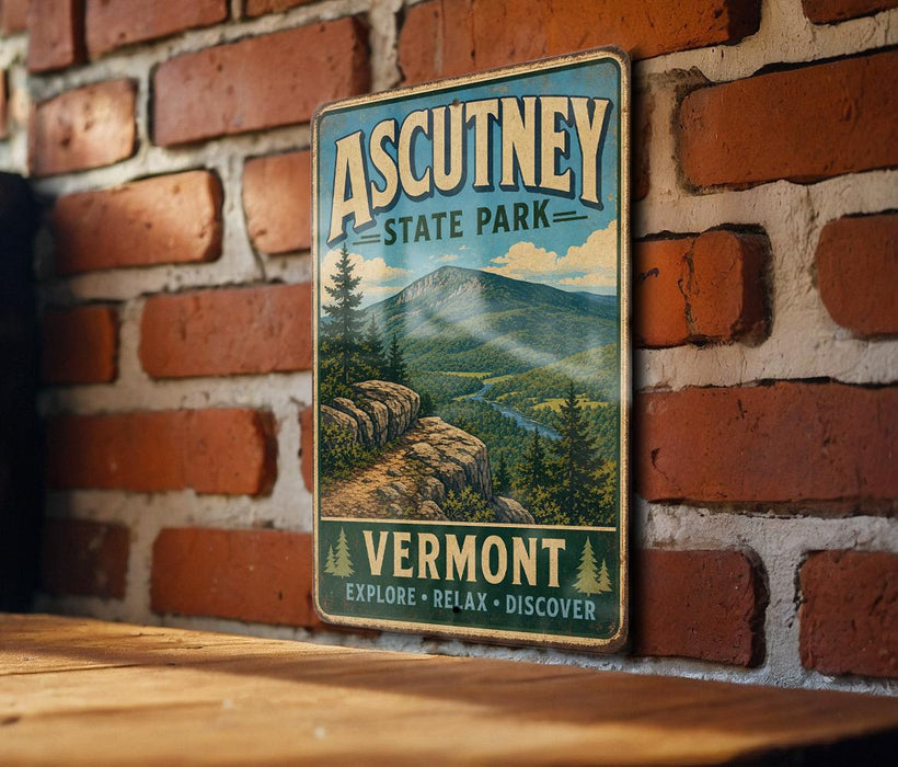 A vintage metal sign for Ascutney State Park in Vermont, featuring a scenic mountain landscape and the words "Explore, Relax, Discover" below.