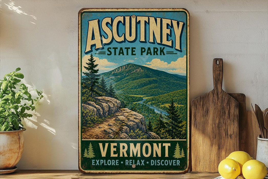 a vintage-style poster of Ascutney State Park, with a mountain landscape and a path leading through the forest. The poster is displayed on a wall, and there are some kitchen utensils, such as a cutting board and a knife, as well as some fruits, such as lemons, in the foreground.