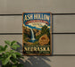 A vintage-style sign for Ash Hollow State Historical Park in Nebraska, featuring a waterfall and a scenic landscape.