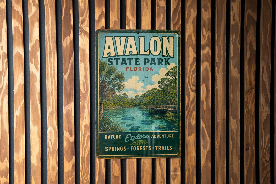 A vintage metal sign for Avon State Park in Florida, featuring a scenic image of a river surrounded by palm trees and a bridge.