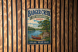 A vintage metal sign for Badger Creek State Recreation Area in Iowa, featuring a scenic illustration of a lake, canoe, and trees.
