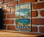 A vintage-style metal sign for Balmorhea State Park in Texas, featuring a scenic illustration of a desert landscape with a pool and palm trees.