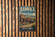 A vintage metal sign for Bannack State Park in Montana, featuring an illustration of a wooden building and mountains in the background.