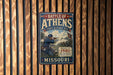 A vintage metal sign depicting a battle scene from the Civil War in Missouri, with a soldier in uniform and a Union flag.