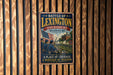 A metal sign with a vintage design hangs on a wooden wall, depicting a battle scene with soldiers and an American flag.