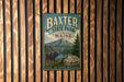 A vintage metal sign for Baxter State Park in Maine, featuring a moose and a pine tree in a scenic landscape.