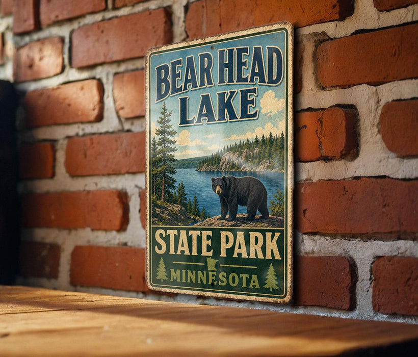 A vintage metal sign for Bear Head Lake State Park in Minnesota, featuring a bear and a scenic landscape.