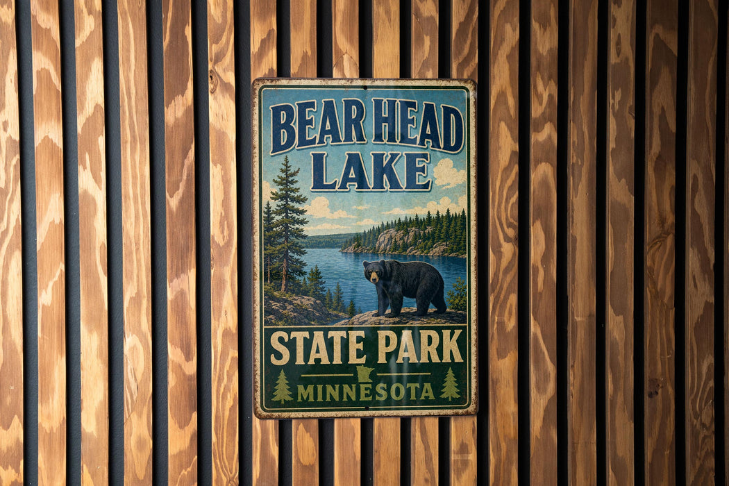 A vintage metal sign for Bear Head Lake State Park in Minnesota, featuring a bear and a scenic landscape.
