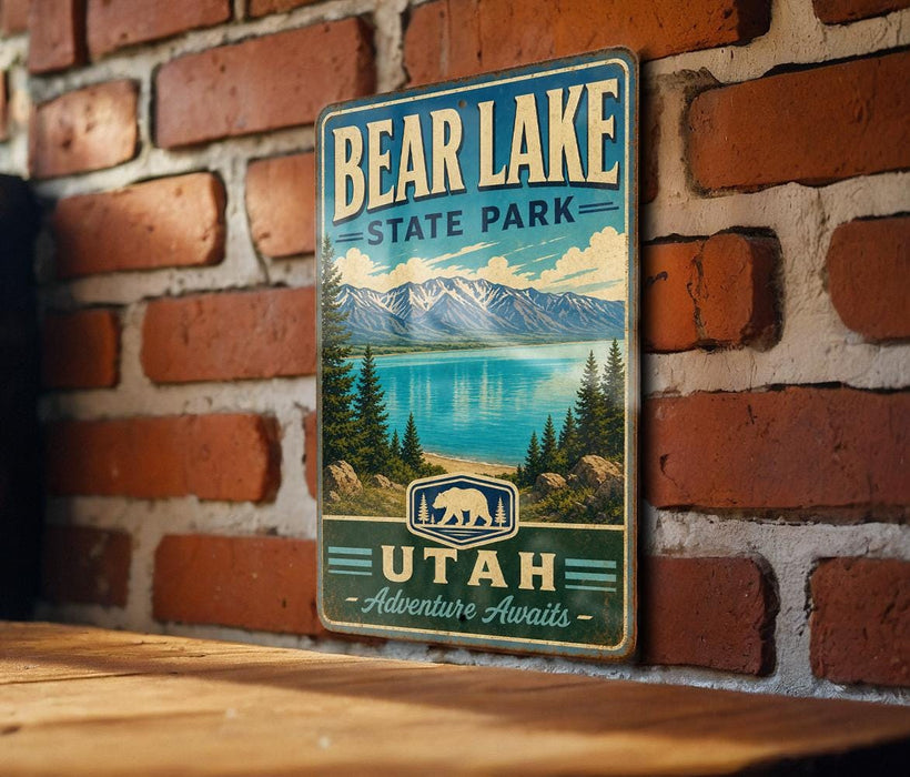 A vintage metal sign for Bear Lake State Park in Utah, featuring a scenic landscape with mountains, pine trees, and a lake.