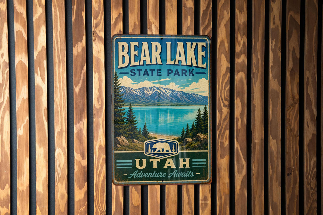 A metal sign with the text "BEAR LAKE STATE PARK UTAH Adventure Awaits" is displayed on a wooden wall.