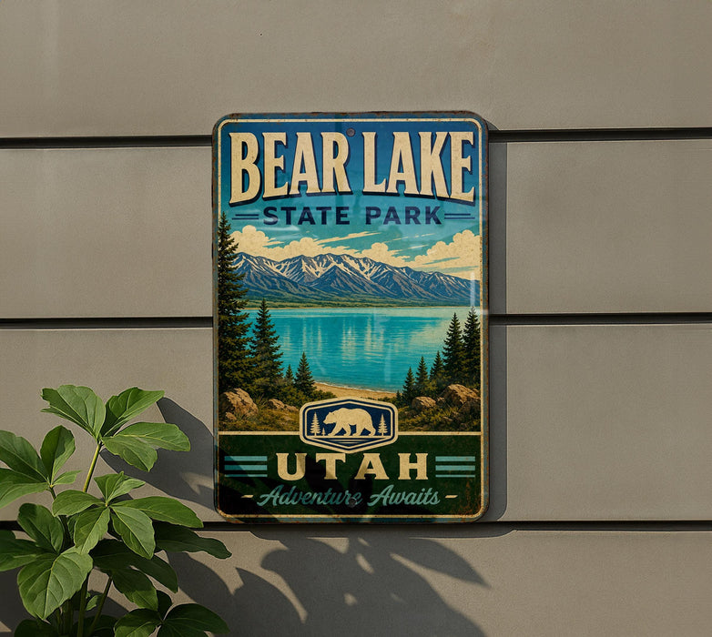 A vintage metal sign for Bear Lake State Park in Utah, featuring a scenic landscape with mountains, pine trees, and a lake.