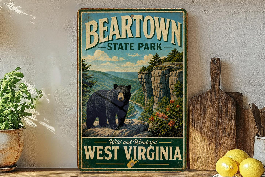 A vintage-style poster of a bear in a mountainous landscape, with the text "BEARTOWN STATE PARK" and "WILD AND WONDERFUL WEST VIRGINIA" printed on it. The poster is displayed on a wall, with a wooden cutting board and a potted plant to the left, and a bunch of lemons to the right.