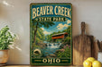 A vintage-style sign for Beaver Creek State Park in Ohio, featuring a scenic illustration of a bridge over a waterfall surrounded by lush greenery.