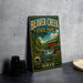 A vintage metal sign for Beaver Creek State Park in Ohio, featuring a scenic illustration of a bridge and waterfall surrounded by lush greenery.