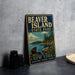 A vintage-style metal sign for Beaver Island State Park, featuring a scenic illustration of a beaver and a lake surrounded by pine trees.