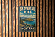 A vintage metal sign for Beavertail Hill State Park in Montana, featuring a scenic landscape with mountains, pine trees, and a lake.