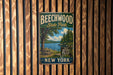 A vintage metal sign for Beechwood State Park in New York, featuring a scenic image of a lake and forest.