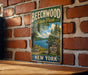 A vintage metal sign for Beechwood State Park in New York, featuring a scenic image of the park and a sign inviting visitors to enjoy nature all year round.
