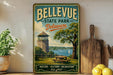 A vintage-style metal sign for Bellevue State Park in Delaware, featuring a lighthouse, picnic table, and a scenic view of the water.