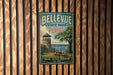 A vintage metal sign for Bellevue State Park in Delaware, featuring a scenic image of a tower, picnic table, and a lake.