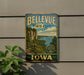 A vintage-style metal sign for Bellevue State Park in Iowa, featuring a scenic landscape with a river, cliffs, and a wooden fence.